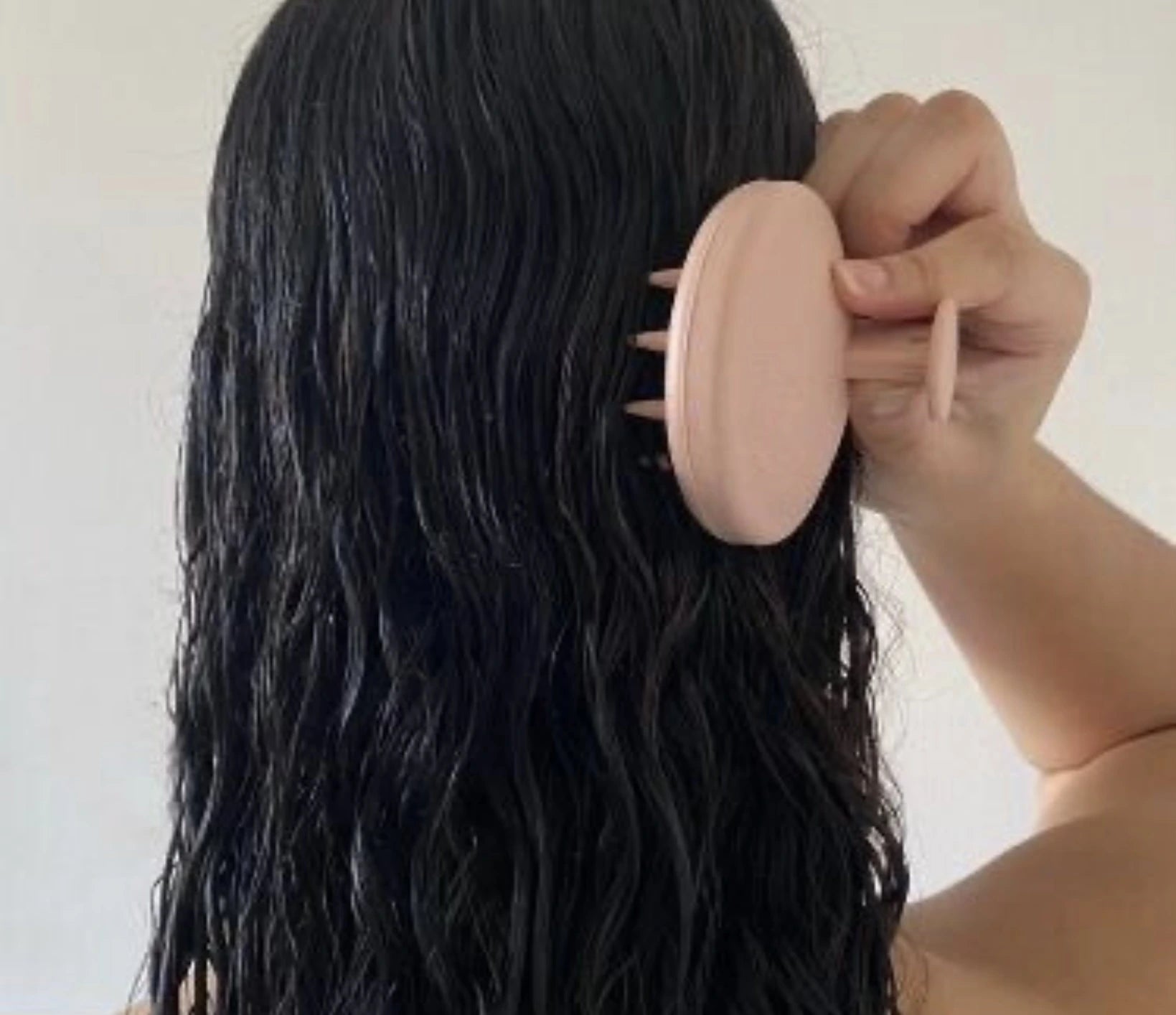 Femme utilisant la brosse exfoliante PEACHSKIN pour cuir chevelu, obtenant des cheveux éclatants et forts. Idéale pour stimuler la circulation sanguine, éliminer les impuretés et favoriser une croissance capillaire saine et brillante.